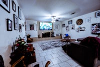 a living room with a tv on the wall